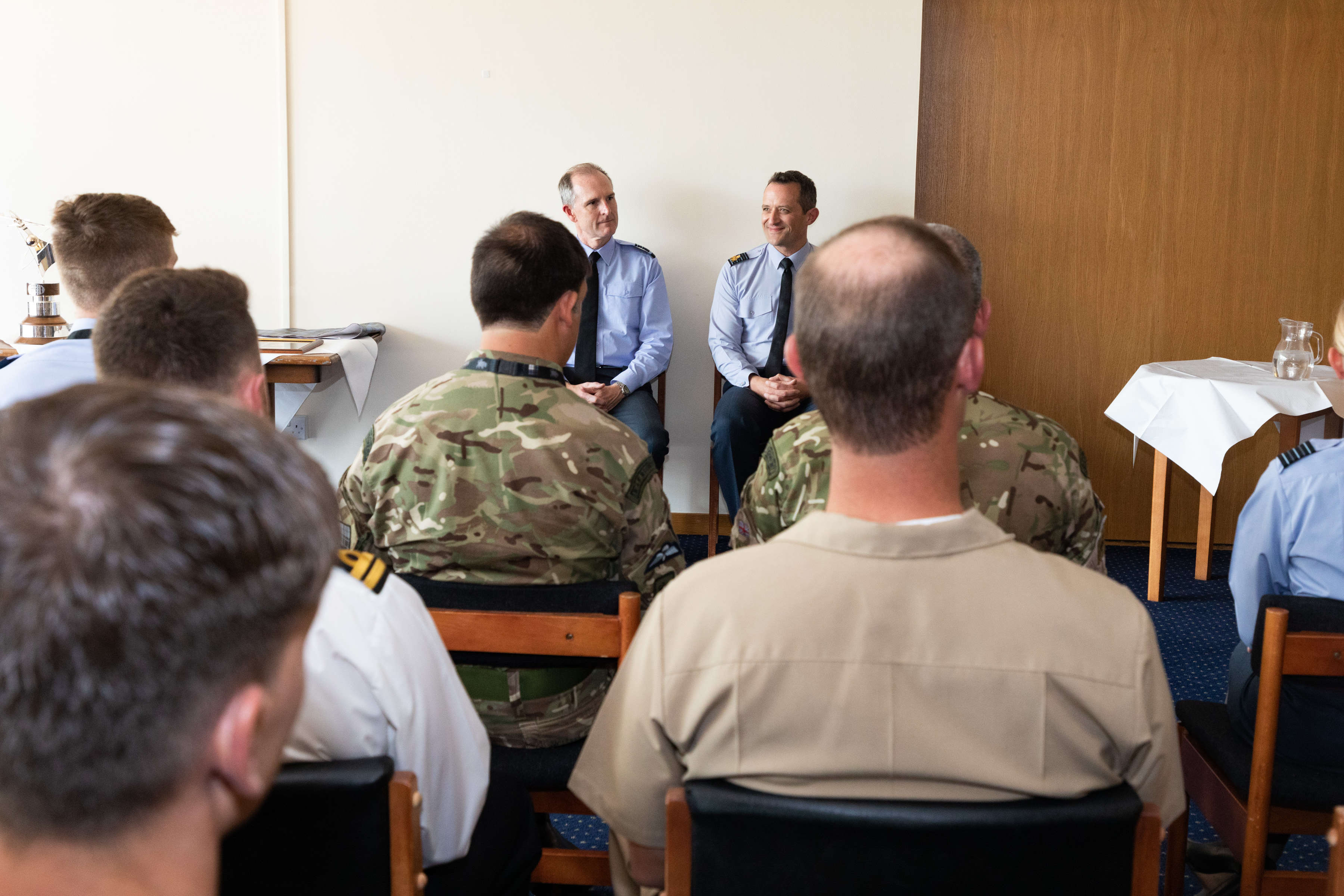 Image shows personnel sitting in the presentation room.